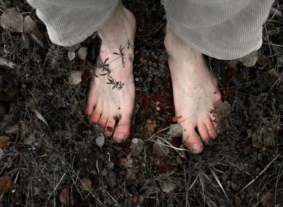 Close-up of feet on a mat, symbolizing connection to the ground.